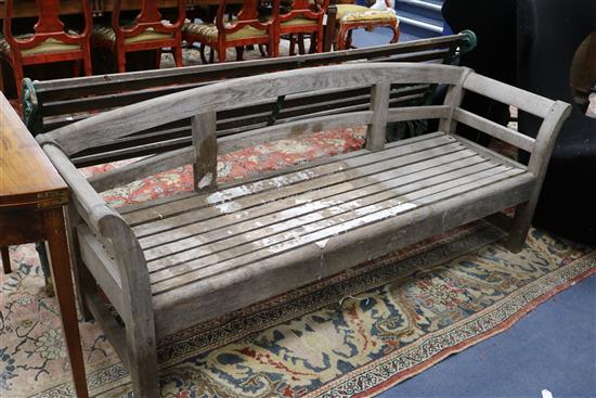 A Victorian green painted wrought iron and teak garden bench and a teak garden bench with slightly curved back W.189 and 183cm